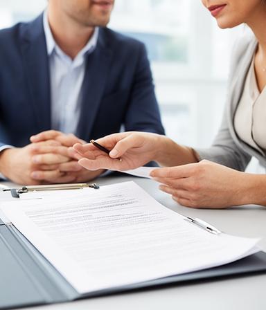 Commercial law expert discussing a contract with a small business owner in a bright office near Carlow town